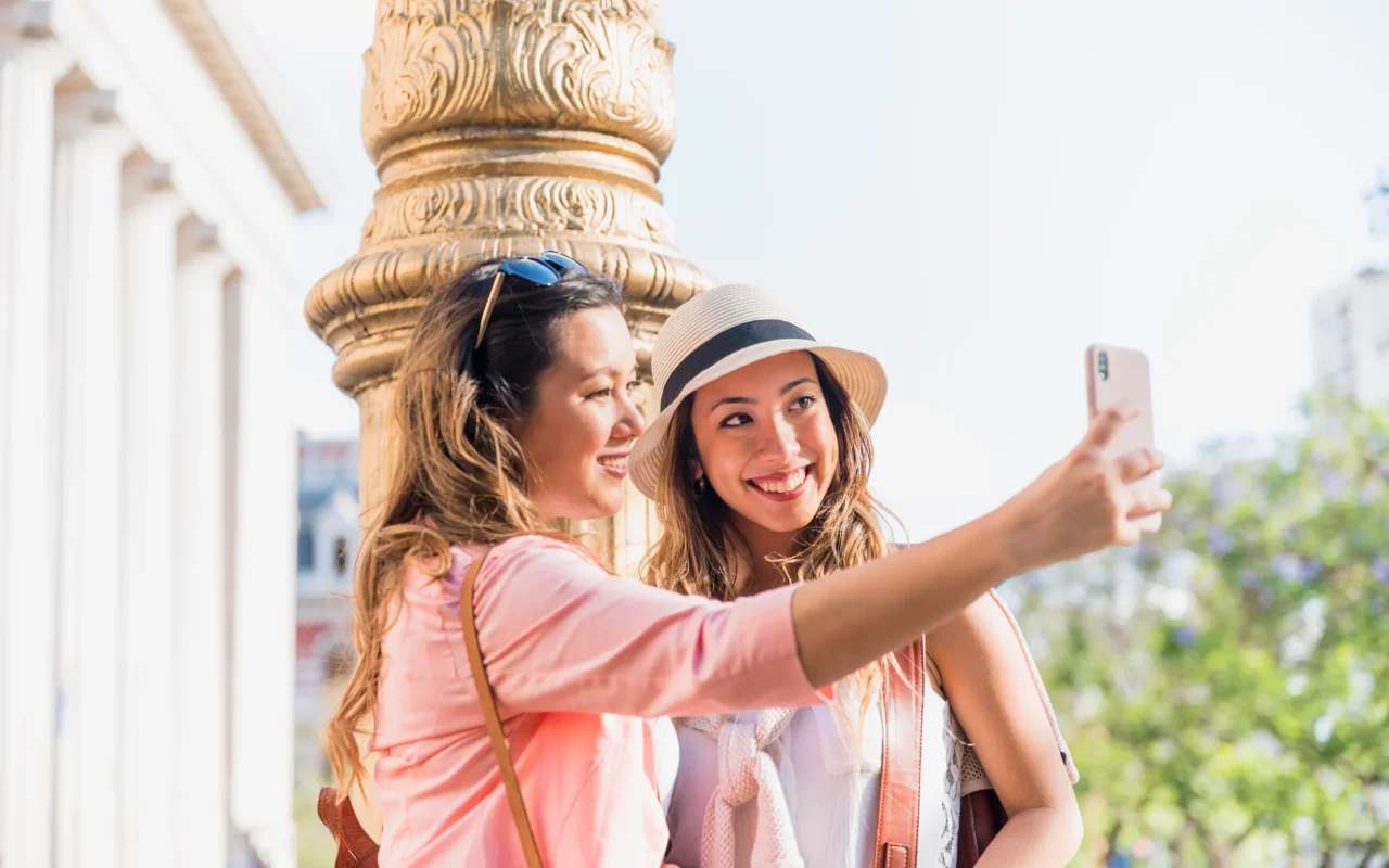 two-happy-female-friends-taking-self-portrait-from-mobile-phone (1)