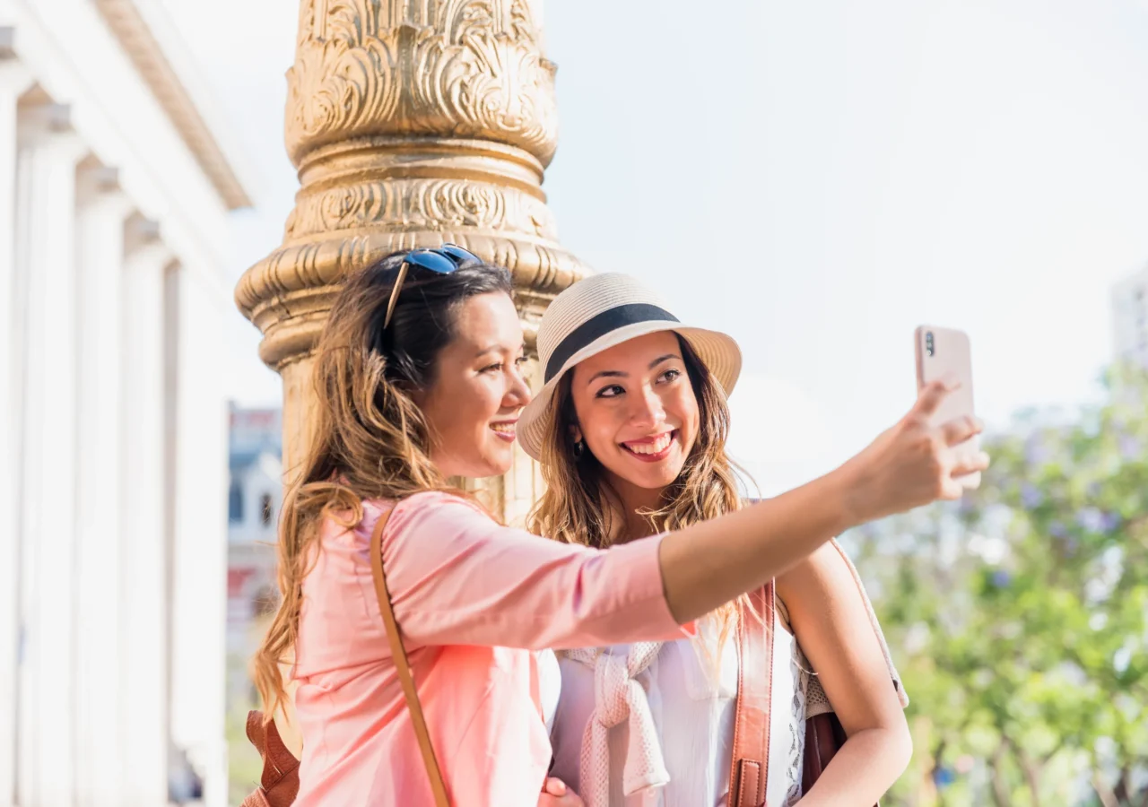 two-happy-female-friends-taking-self-portrait-from-mobile-phone (1)